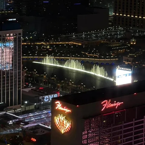 The Bellagio fountains and the Strip lit up at night
